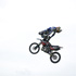 stunt rider leaning back in mid air